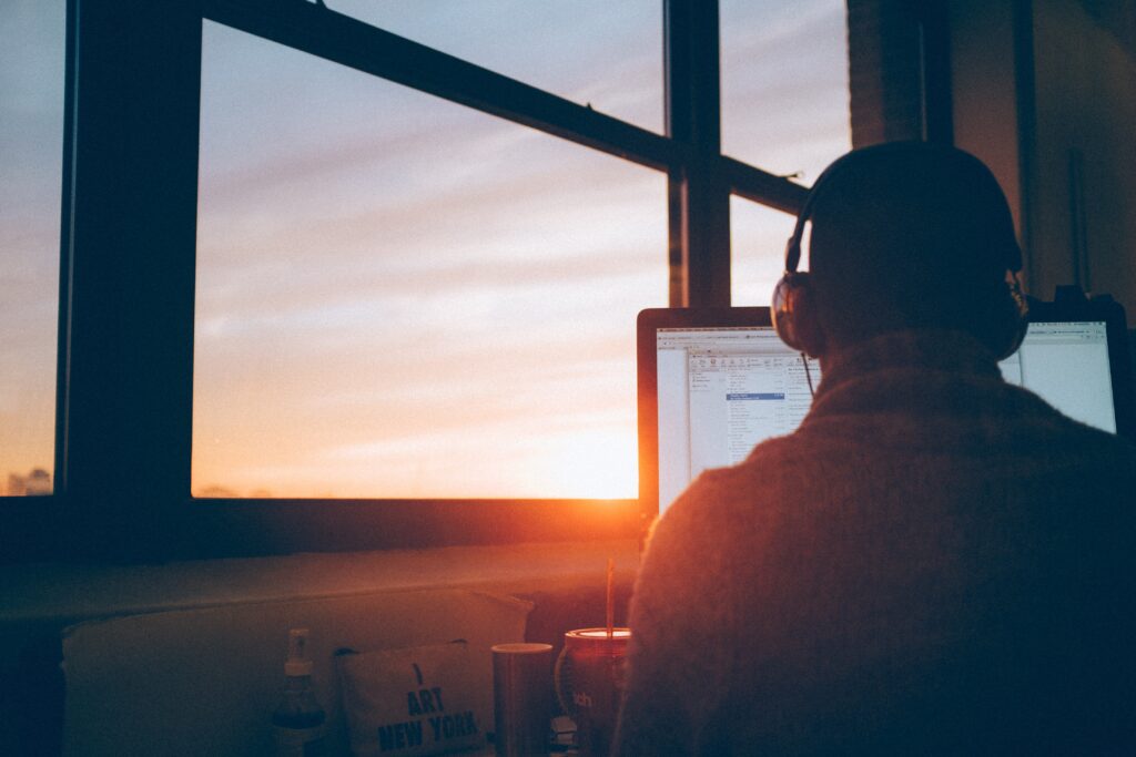 a man working from home with sunset backdrop