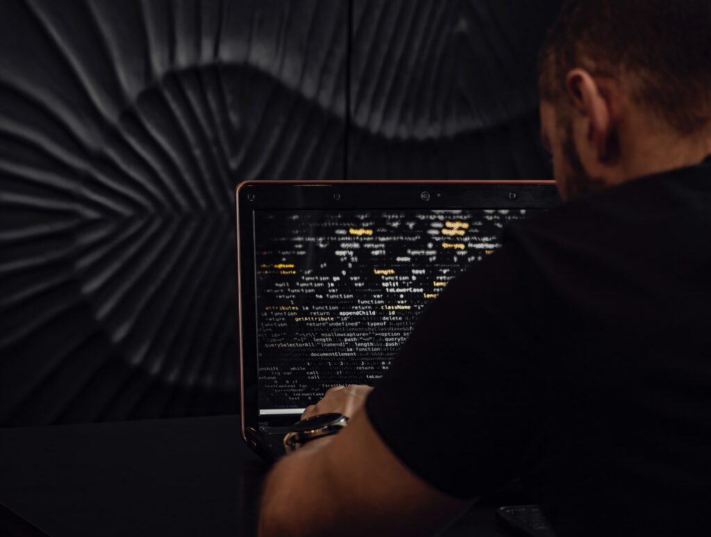 a man facing the laptop screen