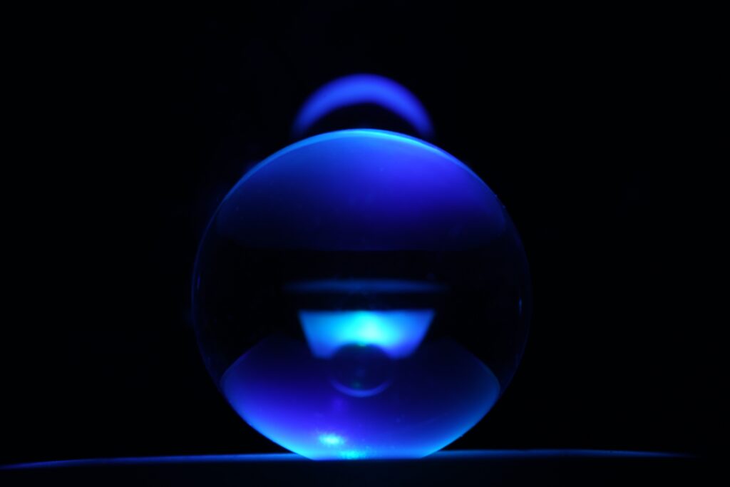 a blue light in a round abstract ball